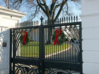 Iron Gates With Green and Red Holiday Wreaths