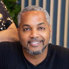 As seen on HGTV's Married to Real Estate, hosts Egypt Sherrod and Mike Jackson pose in the newly renovated living room in the basement of the Weaver's home. (Portrait)